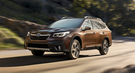 The 2022 Subaru Outback driving on a road.